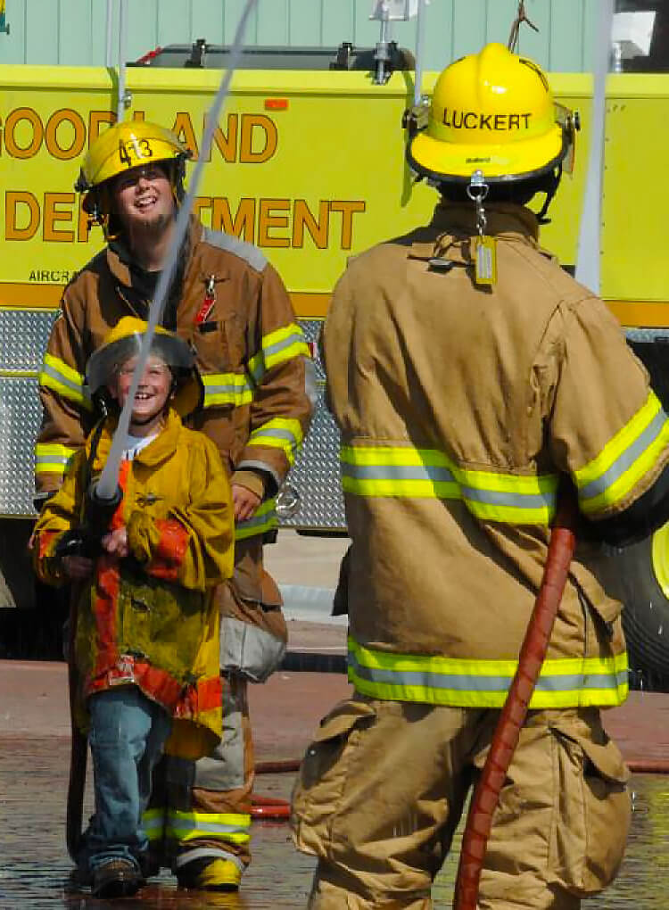 kid spraying fire hose